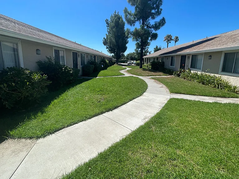 Serene courtyard between apartment units at Eucalyptus Apartments in Moreno Valley, California.