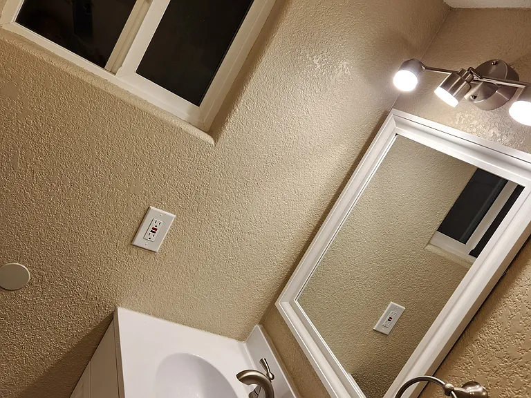 Downstairs sink w/ window, lights and mirror.