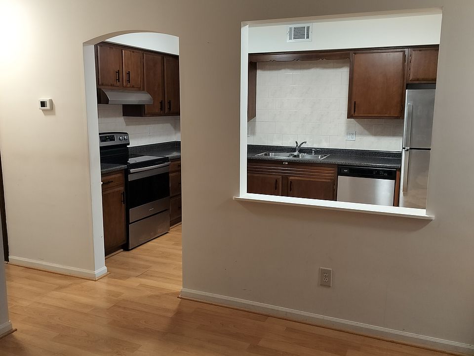 Window opening between kitchen and living room makes rooms feel spacious.