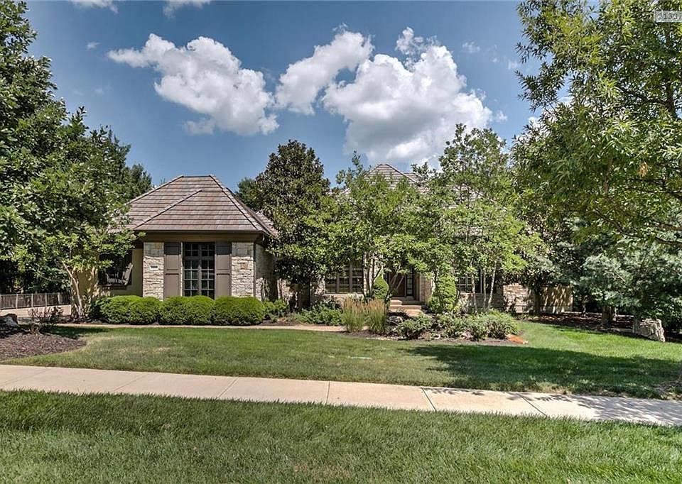 Custom-built B&F Home with tile roof, stucco and stone exterior.