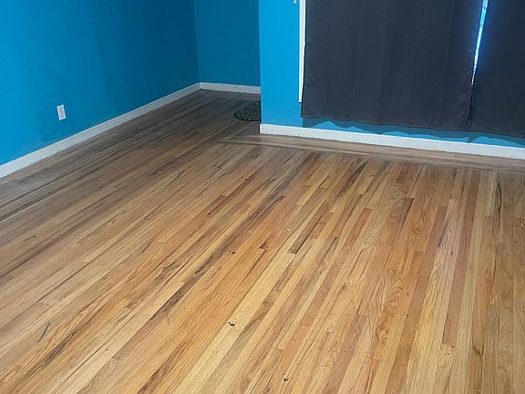 Living Room: huge front window & hardwood floor & bright colored