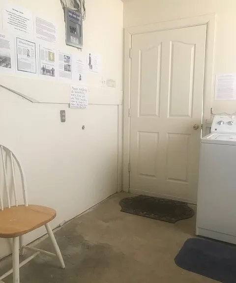 Laundry rom with front door closed.