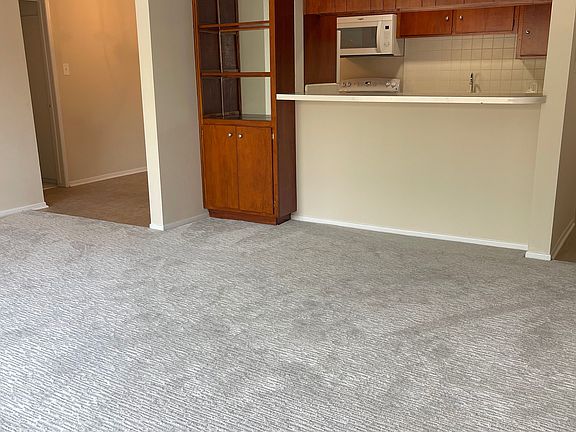 Living room to dining area, view to kitchen, breakfast bar