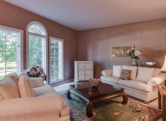 Spacious living room with fantastic windows overlooking front of home