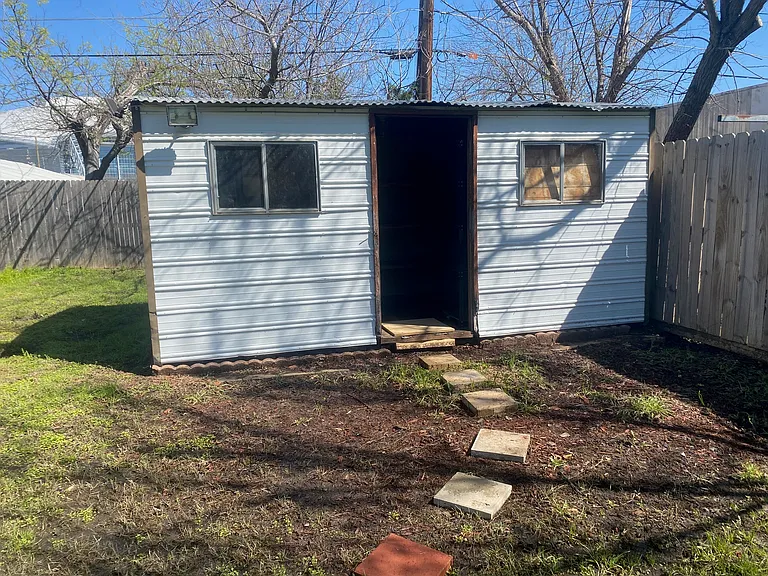 Storage building on back of backyard.