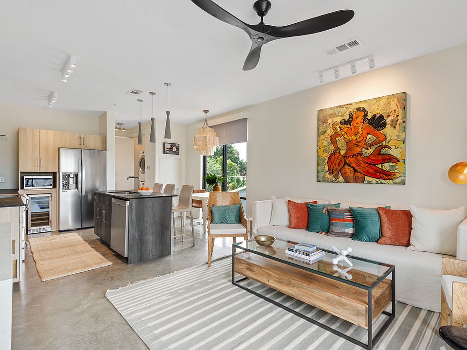 The living room features a 65" TV and original art from Paul Tamanian.