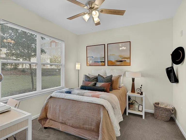 Rest in comfort with a spacious bedroom, walk-in closet, and private bathroom at The Flatts Starkville student apartments