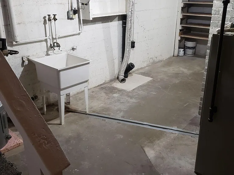 Unfinished basement with storage and w/d hookups