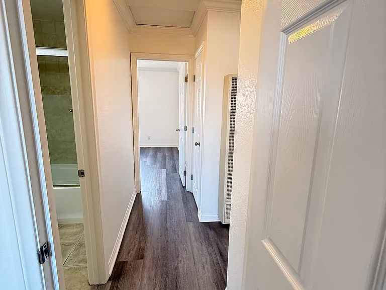Hallway with bathroom between the two bedrooms