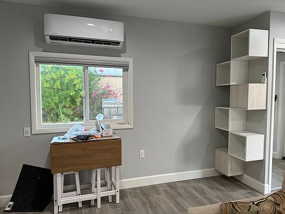 Mounted cubes for additional storage next to full size closet with mirror doors.