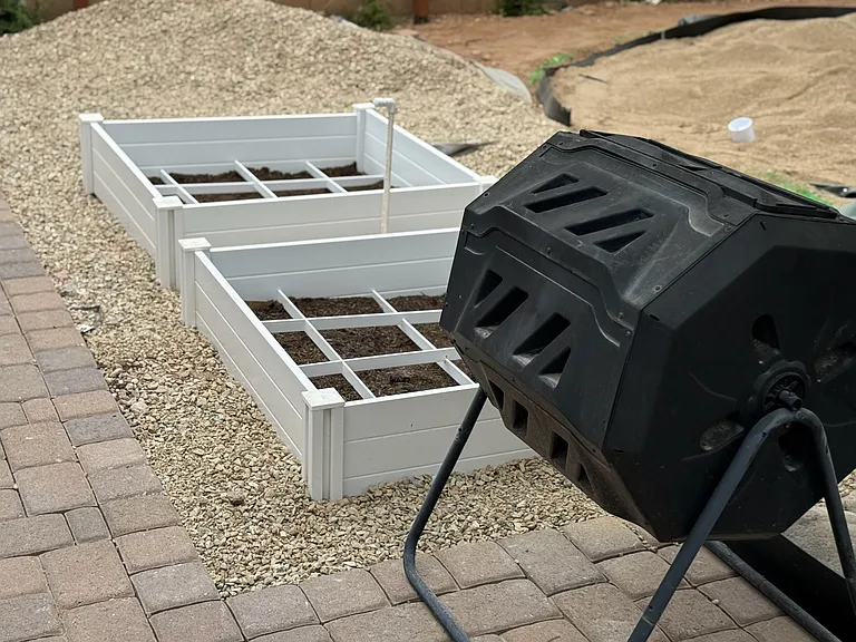 2 garden boxes with separate watering system for the avid or budding gardener. Compost station is included. Putting green is being worked on in the background :)