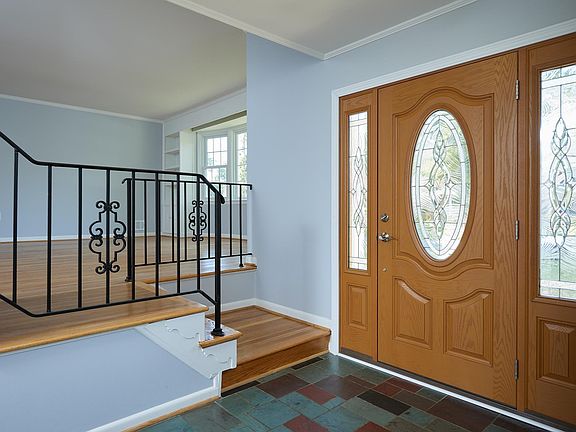 Entrance with new decorative door and large coat closet.