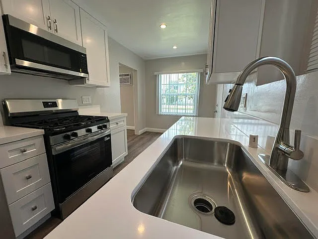Newly remodeled kitchen with brand new appliances (fridge, stove, dishwasher, and microwave)