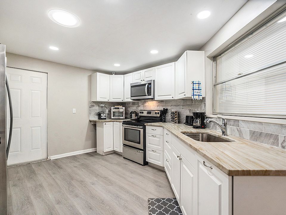 Remodeled kitchen comes complete with a large refrigerator, microwave, air fryer, and range/oven, along with the standard cooking utensils, pots, pans, plates, cups, glasses, and silverware. Each room has a minifridge too.