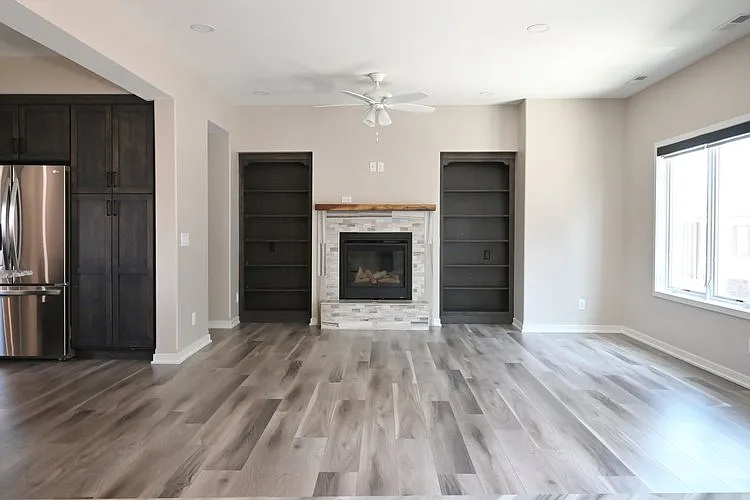 Living room with electric fireplace at Lyric Townhomes.