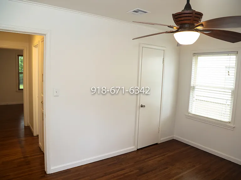 2nd bedroom looking toward primary bedroom. Door to the right is closet.