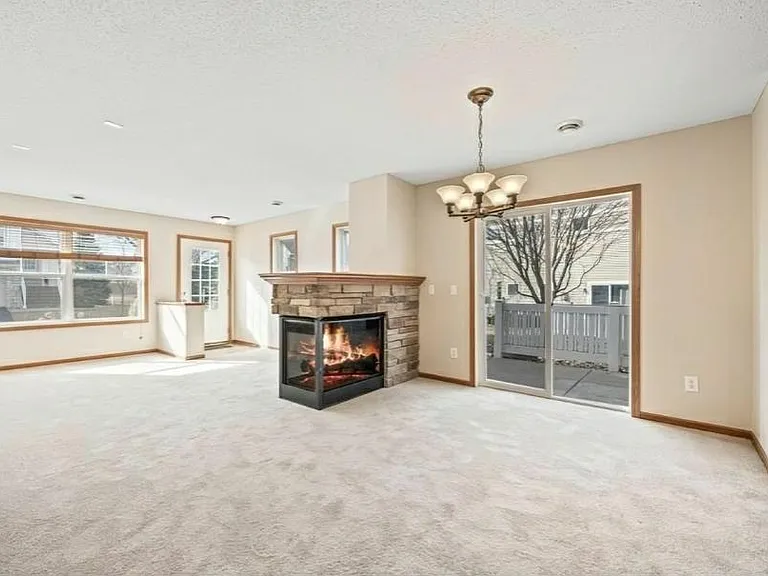 Another view with Living room and dining area with 3-sided Fireplace. Looks great! House has new carpet and Fresh Paint throughout.
