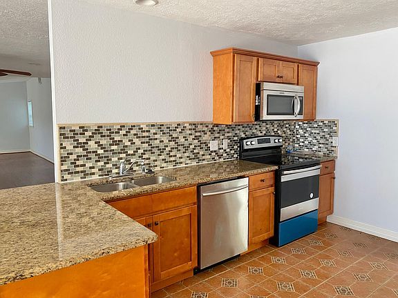 Granite countertops, stainless steel appliances (dishwasher, microwave/vent hood/stove-oven). Brand new glass-top electric stove.