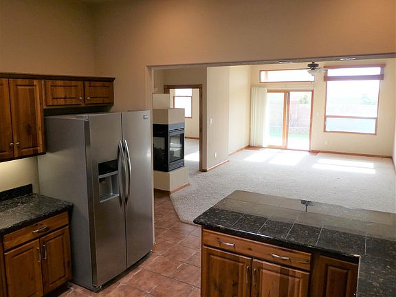 View from kitchen through dining room/living room to back patio.