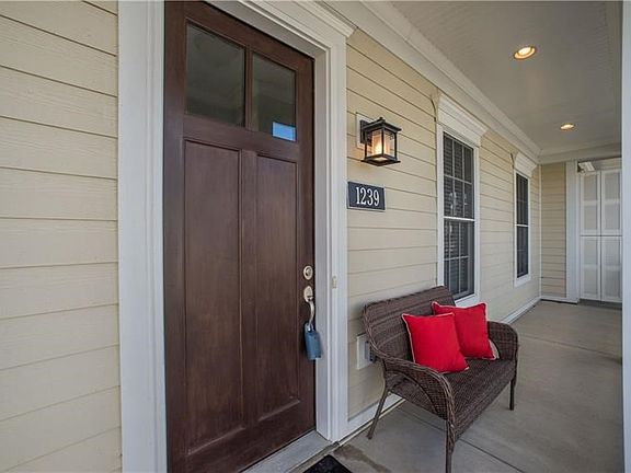 The wide covered front porch welcomes you and your guests to 1239 Newbury Highland.