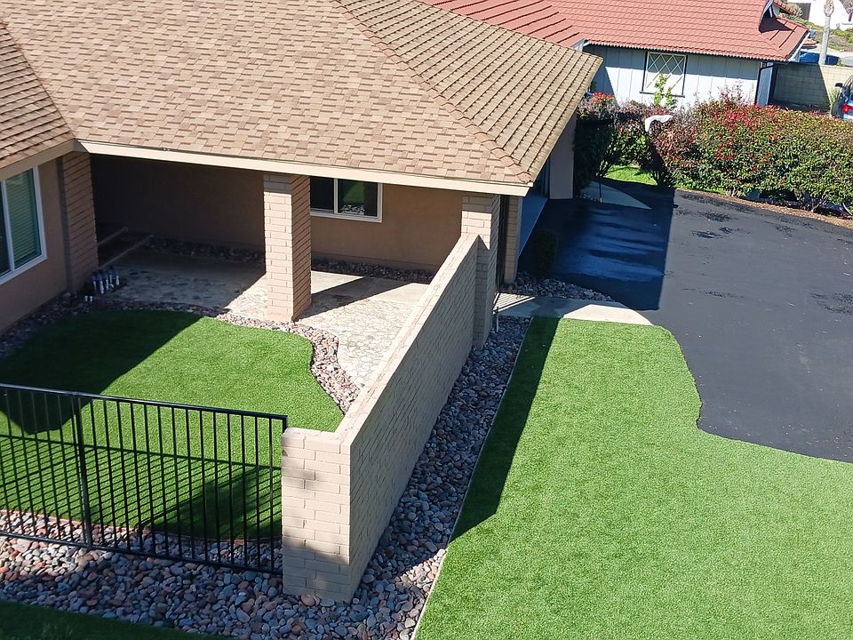 Front of property showing driveway, front yard and courtyard, with gated entryway.