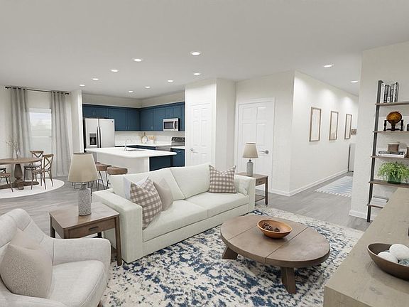 Downstairs, enjoy a welcoming, open-concept living area - Rendering of the Blakely by Highland Homes