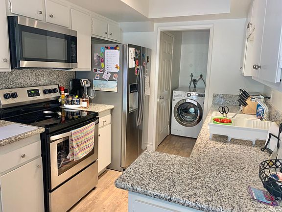 Kitchen includes new flat top stove and dishwasher. Connecting laundry area with hookups and a pantry closet