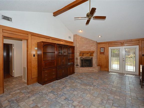 Huge living area with french doors that lead to the flagstone patio in the backyard!