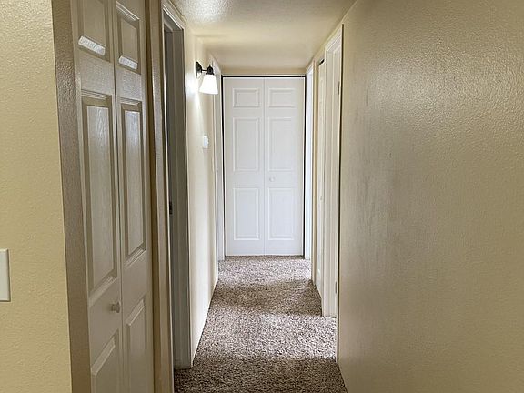 Hallway to bedroom, bathroom and laundry closet.