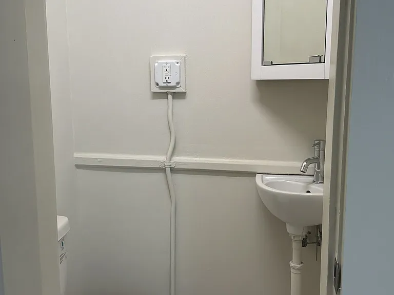 Powder room off second bedroom in the back of the unit.