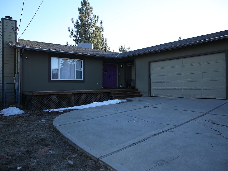 Front with large driveway and 2 car garage works with remote