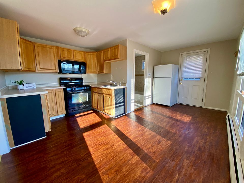 Main entry door, fridge, kitchen and bathroom.
