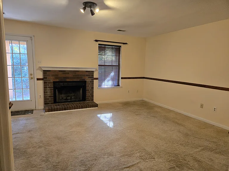 Basement w/Woodburning Fireplace to backyard patio