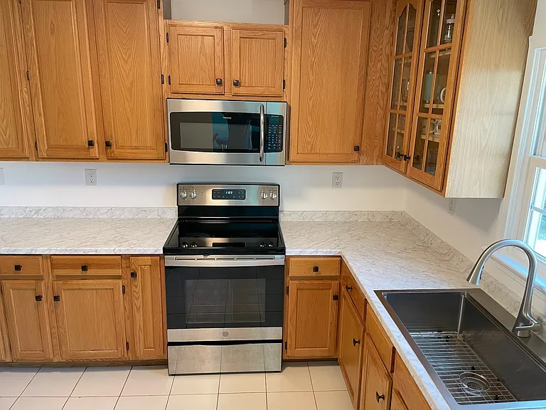 Great open kitchen with brand new stainless refrigerator.