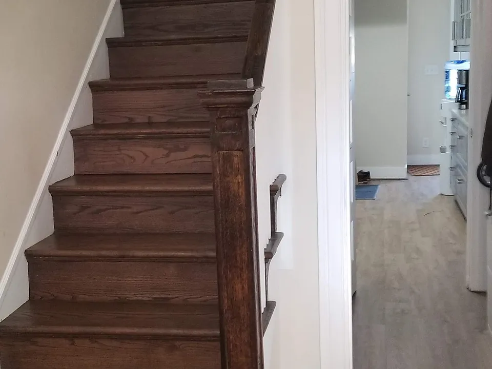 View from foyer into hall closet on right, pantry on left, through to galley kitchen