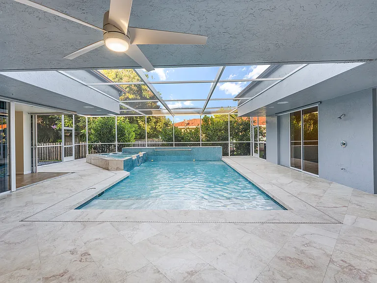 Screened pool and spa surrounded by the home