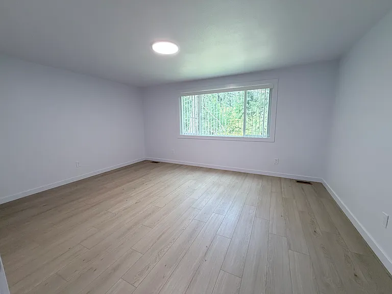 The second bedroom is bright and versatile, perfect for home office.