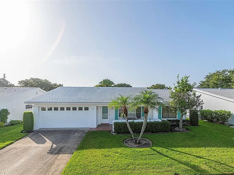 Exterior of the home. All landscaping is taken care of. Just relax in this fully furnished home complete with outdoor grill and covered patio seating.
