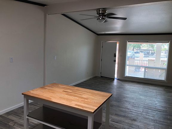 Living room with the kitchen behind you