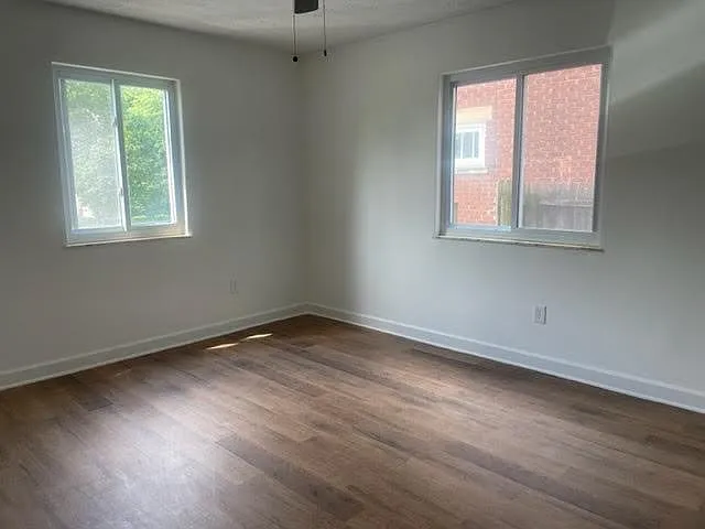 Bedroom with 2 windows and new flooring.