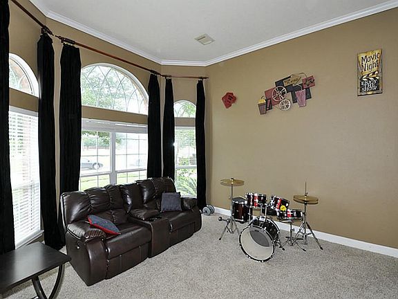 This can be a Study or Media room. The black-out drapes stay with your home.  This room also has a set of double doors to buffer the sound.