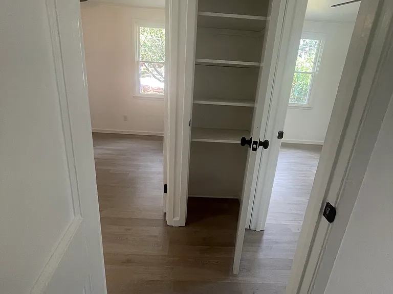 linen closet in hallway between bedrooms