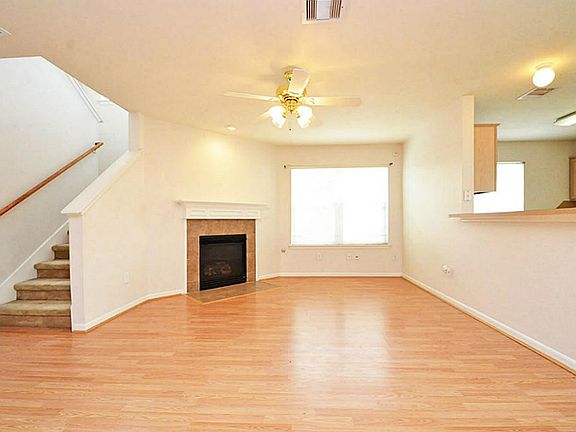 Beautiful & spacious living room with laminate floors gas fire place and arched door ways