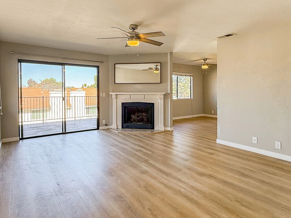 Open, spacious, light and bright living room that opens out to the balcony and leads in to the dining and kitchen. Brand new luxury vinyl plank flooring, neutral paint colors, a gas burning fireplace.