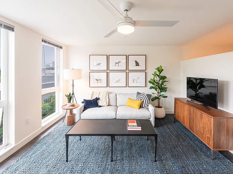 Living Room with Floor to Ceiling Windows and a Ceiling Fan