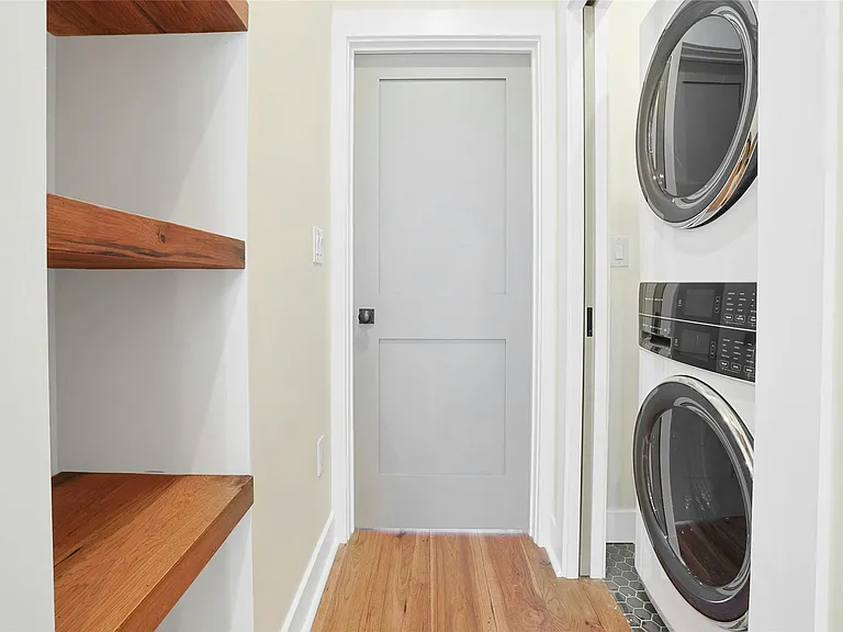 Hallway: Custom shelves in hallway as you walk bedroom. In-unit laundry features new washer and dryer inside closet with pocket doors.