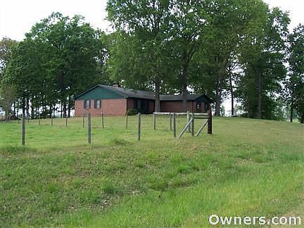 Country living top a grassy knoll near city