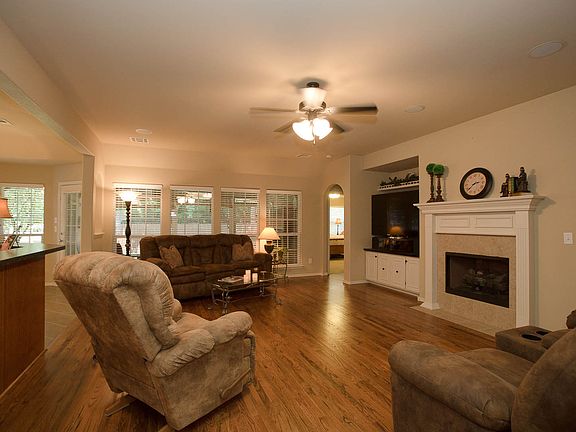 Family room with wall of windows open to kitchen.