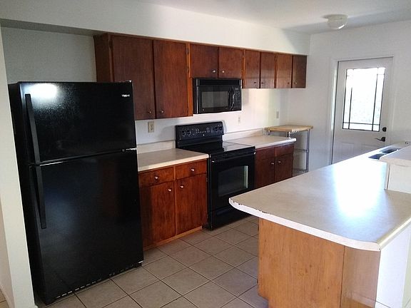 Kitchen with fridge and smooth top electric stove