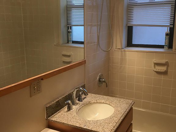 MODERN BATHROOM WITH BRAND NEW VANITY WITH GRANITE COUNTERTOP AND KOHLER FAUCET